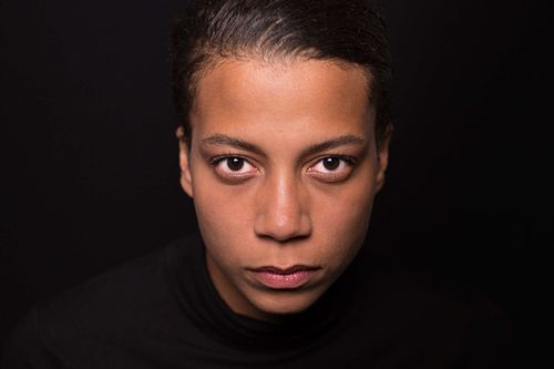 A headshot of a woman in a black turtleneck.