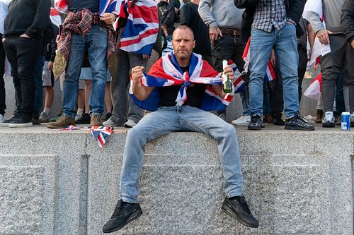 Protesters climb Trafalgar Square plinth during “Unite the Kingdom” rally, London, UK