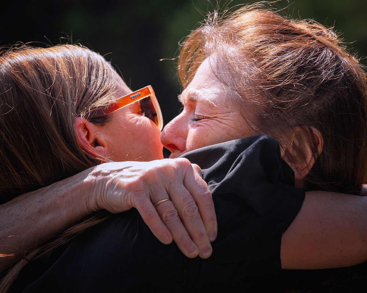 parent tearfully hugging after a Jewish wedding ceremony