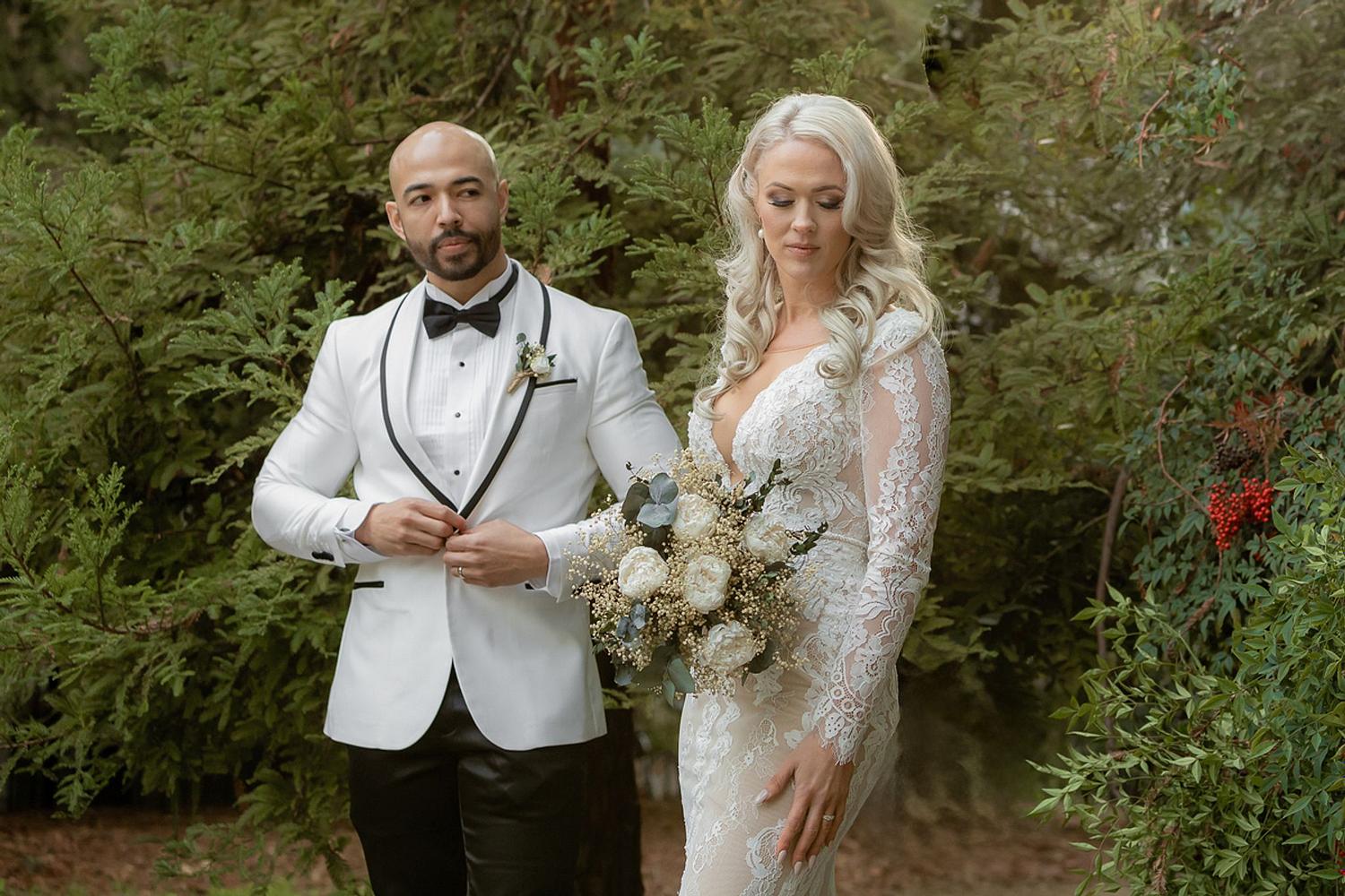 Bride & groom in all white in woods