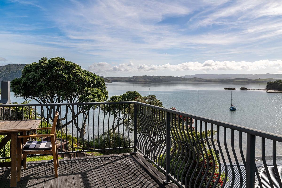 Architectural balcony view of a luxury waterfront property in Lorenzen Bay, Raglan by Flax Cove Studio.