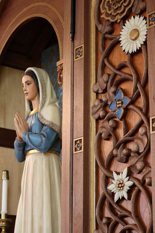 Total statue restoration and new custom, hand-carved shrine for a statue of St. Bernadette Soubirous by Wes and Kelly Baker in walnut, cherry, polychrome paint, and gold leaf