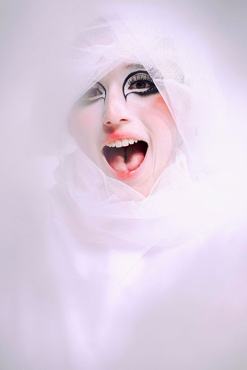 High-fashion pose with dramatic costume, studio photography by Mila Filippone.