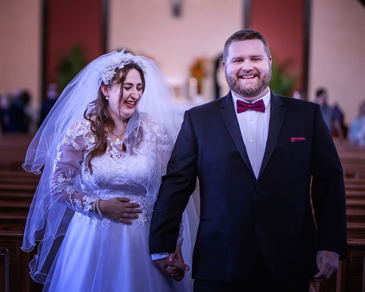 bride and groom walking down the aisle after ceremony at St. lukes, lewes delaware
