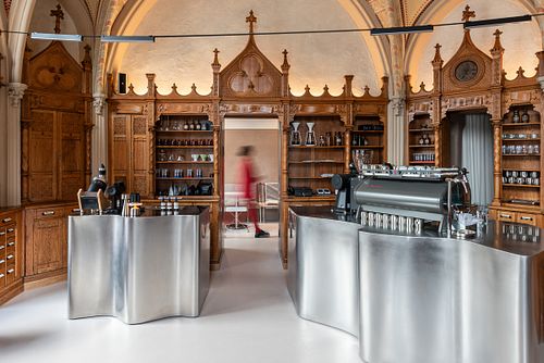 Coffee shop interior with person walking