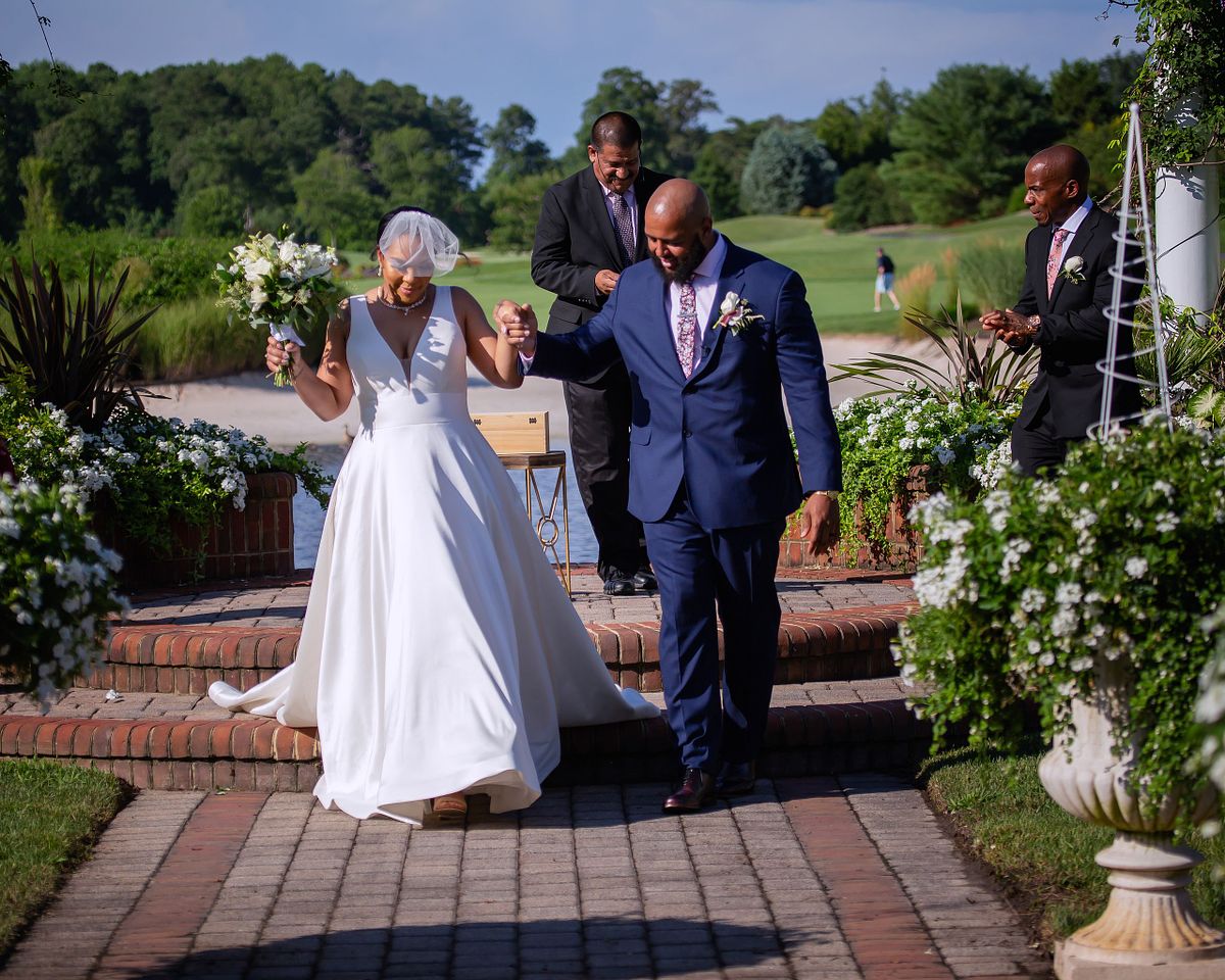 groom and bride walking down the aisle after ceremony on a sunny day