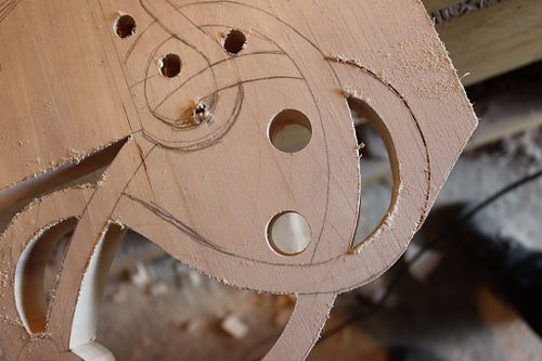 happy face cut out in rope for coat of arms