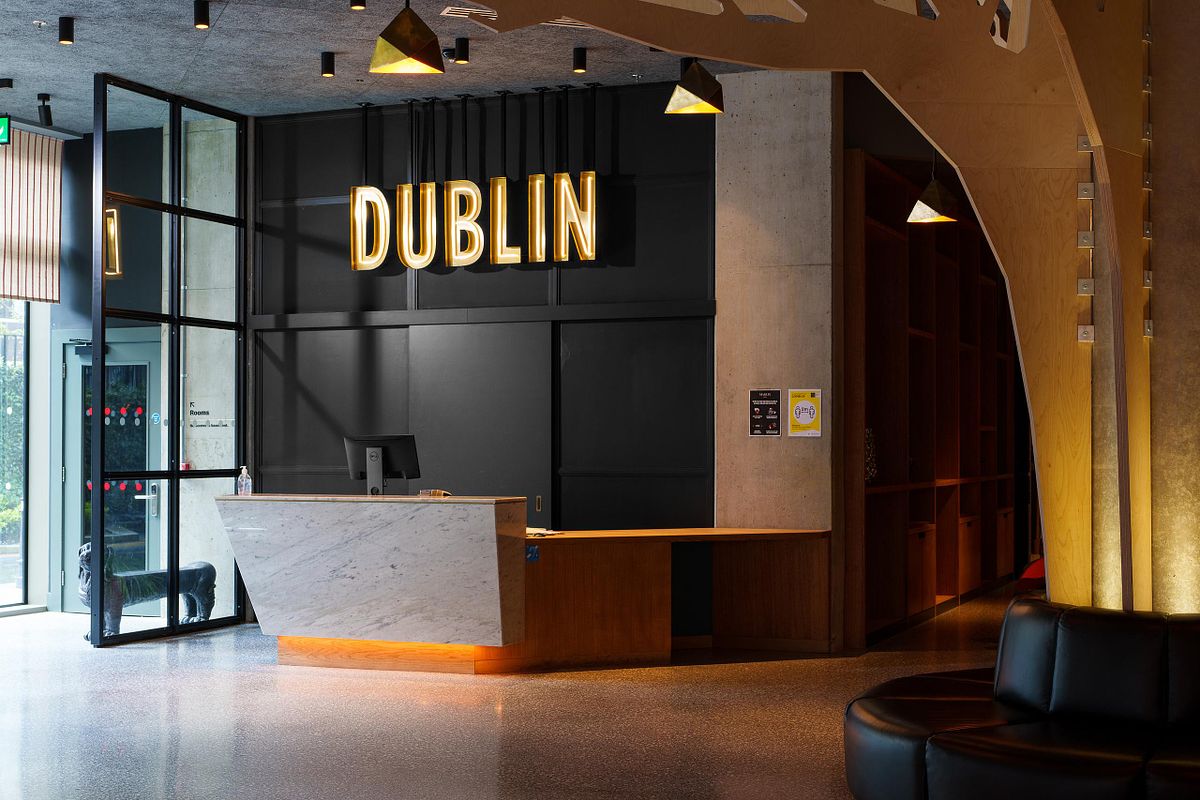 Interior photograph of the reception area at the Marlin Hotel Dublin, featuring a prominent "DUBLIN" sign and modern design