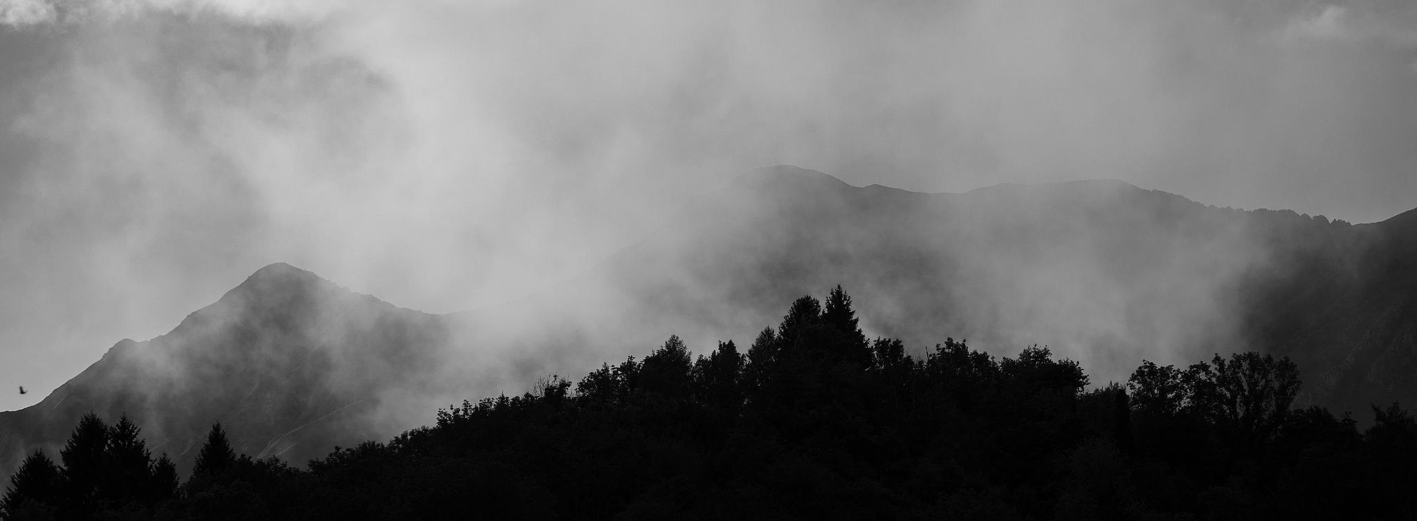 Panoramic mountain ridges fading into atmospheric mist – fine art landscape photography
