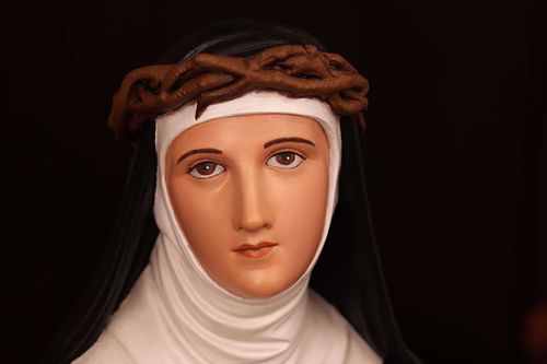 St. Catherine's face after beautiful statue restoration by Kelly Baker of Contrasts Woodcarving for Holy Trinity Catholic Church in Somerset, Ohio