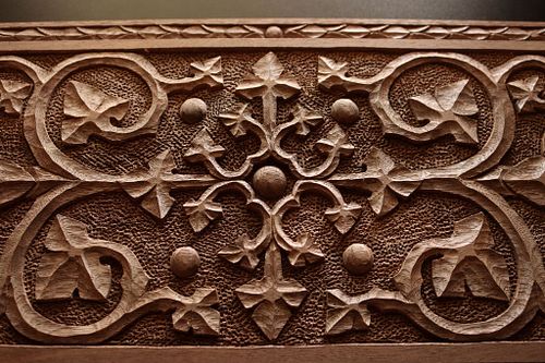 closer detail of the face carving inspired by Gothic Revival architect A.W.N. Pugin