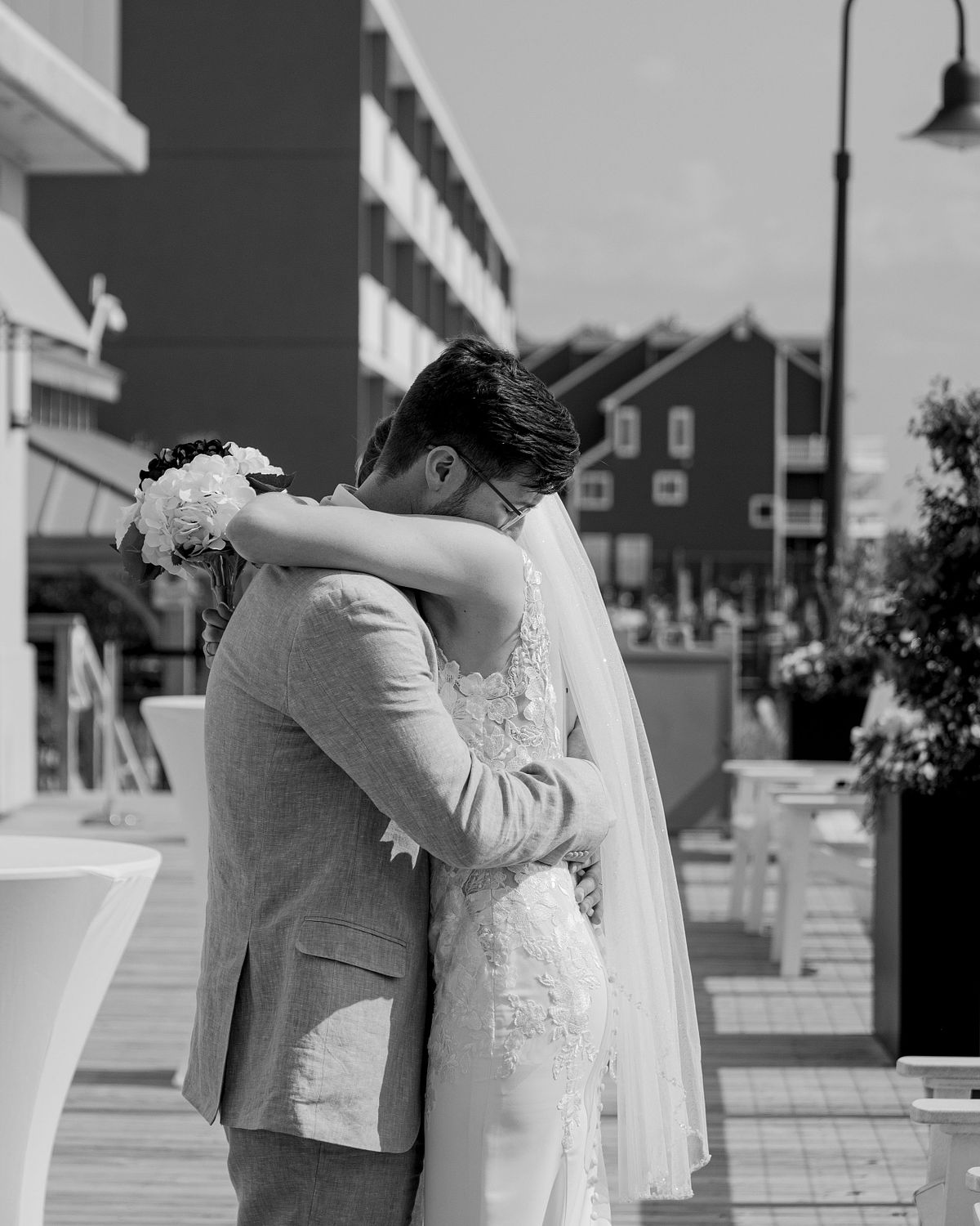 black and white photo of the bride and groom hugging each other at hyatt in dewey beach, sussex county, de