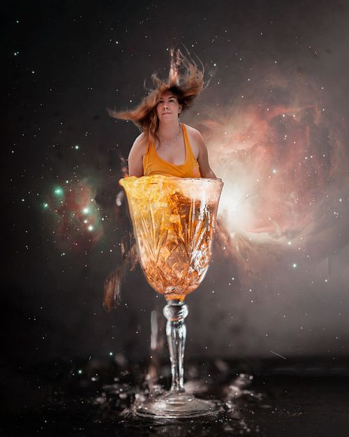 A woman bursting out of a champagne glass.