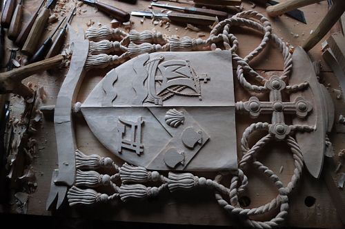 nearly finished carving Bishop Fernandes' symbols on the sinister side of the escutcheon