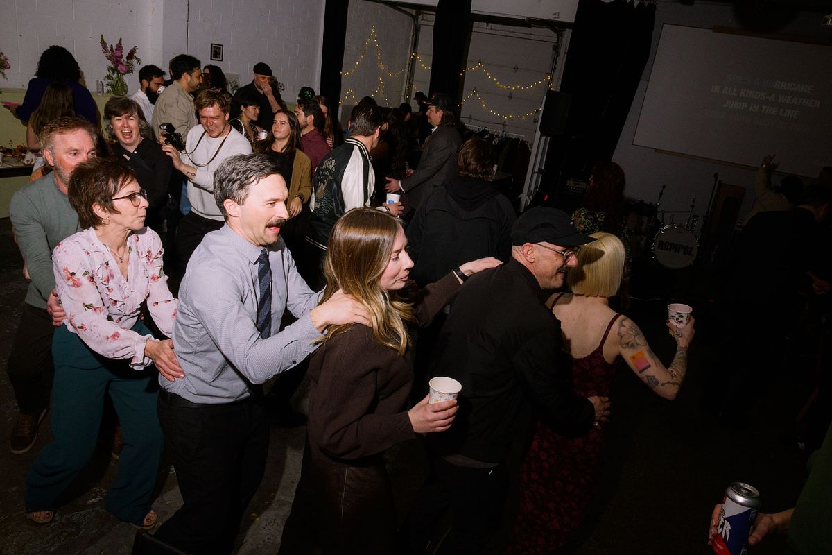 people having fun in conga line at a Vancouver engagement party