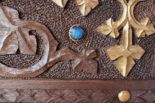 a closer detail of a blue bead painted to look like a gemstone