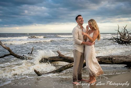 Couple embracing after a surprise sunset beach proposal in Florida, captured by Legacy of Love Photography.