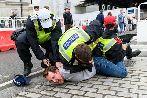 Man is arrested in Trafalgar Square for antagonising protesters at the Stand Up to Racism to counter protest, UK