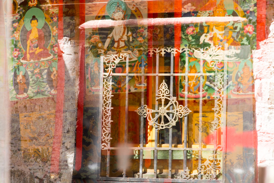 Tibetan symbolism and tapestries in image with multiple reflections