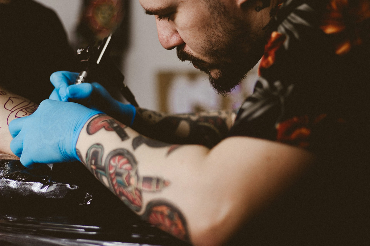 Tattoo artist inking