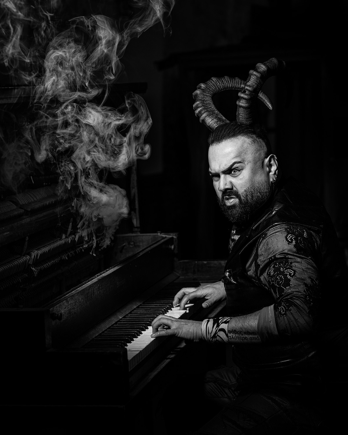 Dramatically lit portrait of a devil playing piano.