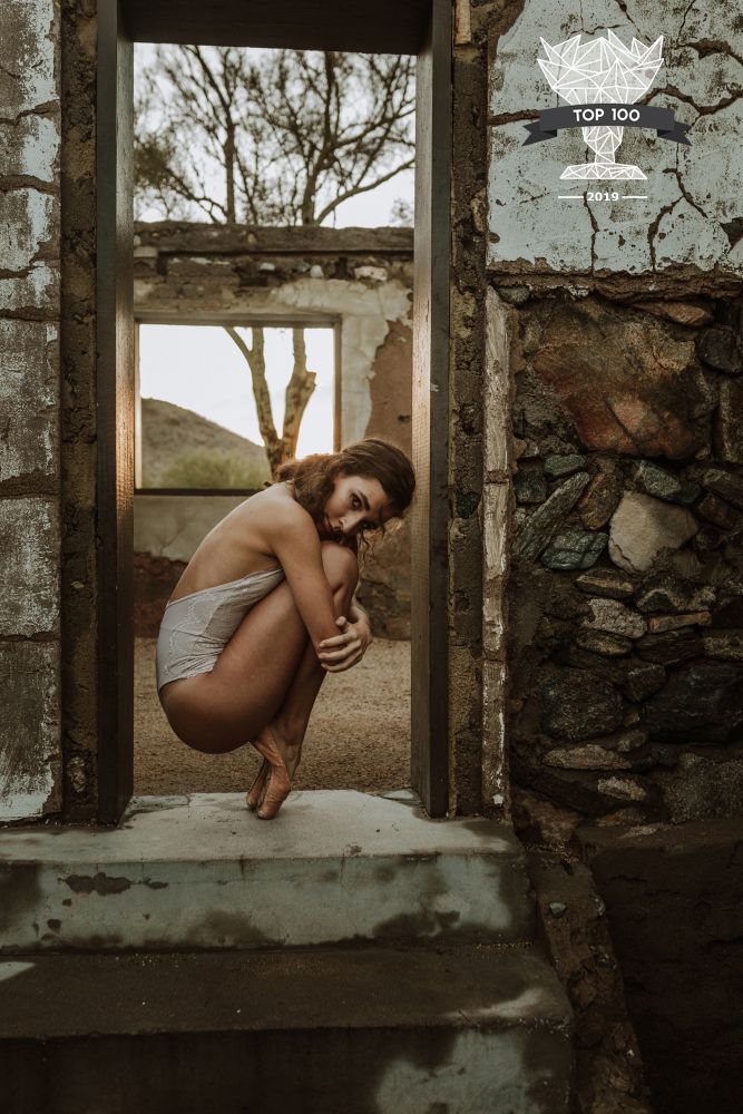 Fine art portrait of a woman in ballet attire blending elegance, strength, and femininity.