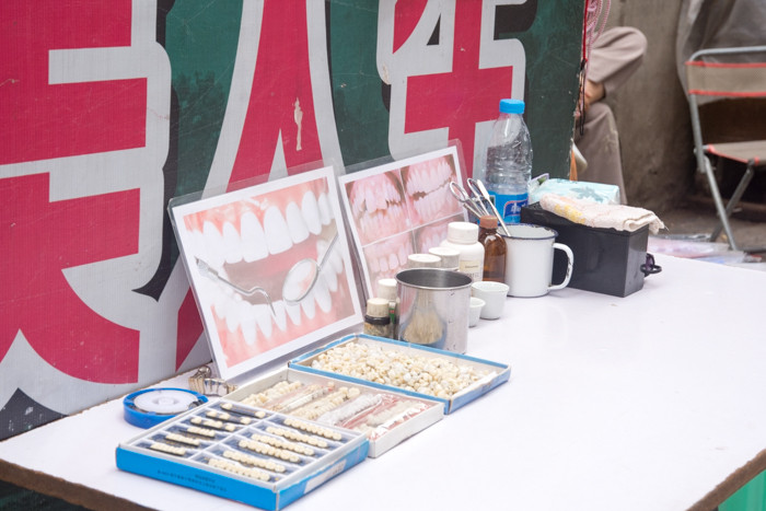 Dental services display on sidewalk in China