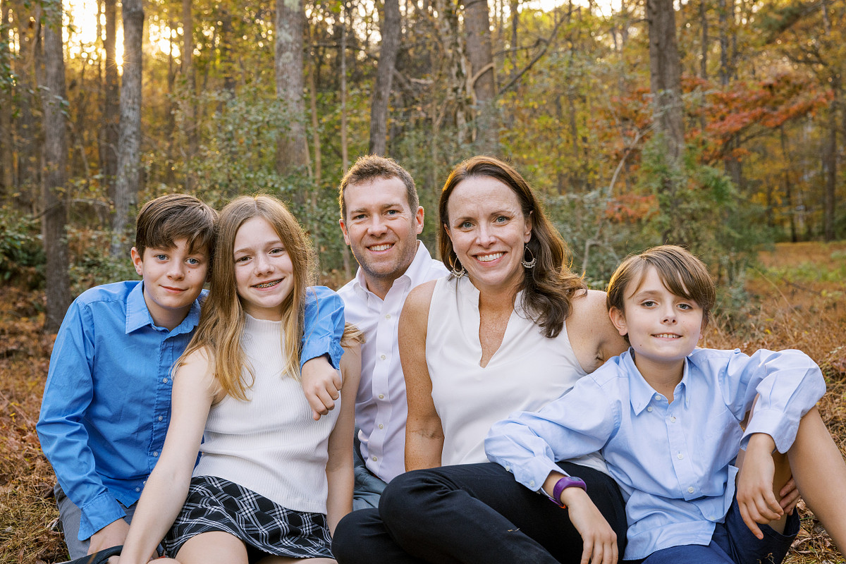 Family sitting together in fall in Carrboro, NC