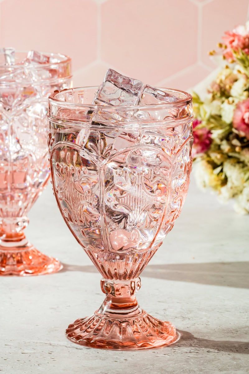 A pink glass with iced drink