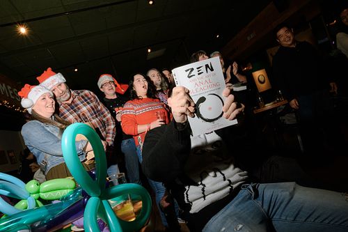 a candid photo of white elephant game at a christmas party in Vancouver