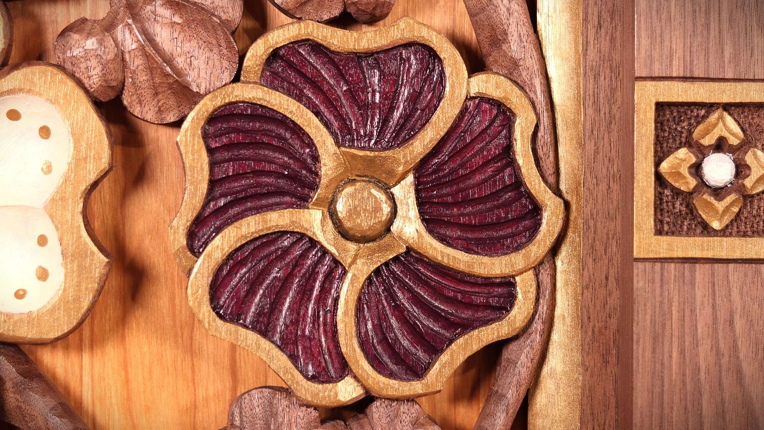 Hand-carved hollyhock flower with purple and gold paint