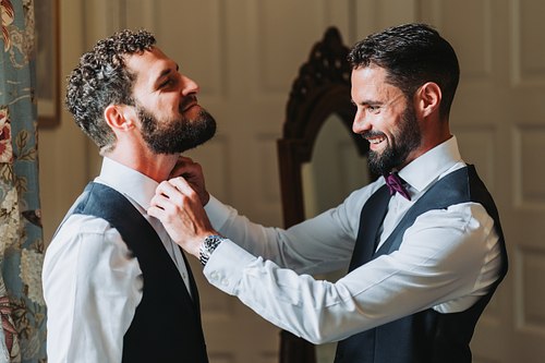 Groom and best mad getting ready