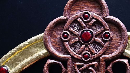 Close up detail of one of the Celtic Roundel Carvings after stain and polychrome.