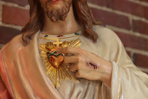 The Sacred Heart painted a fading gold color before restoration