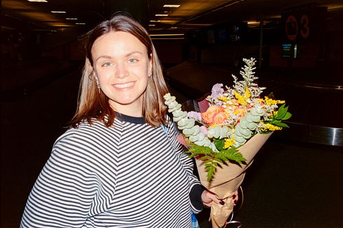 film photo of girl holding flowers