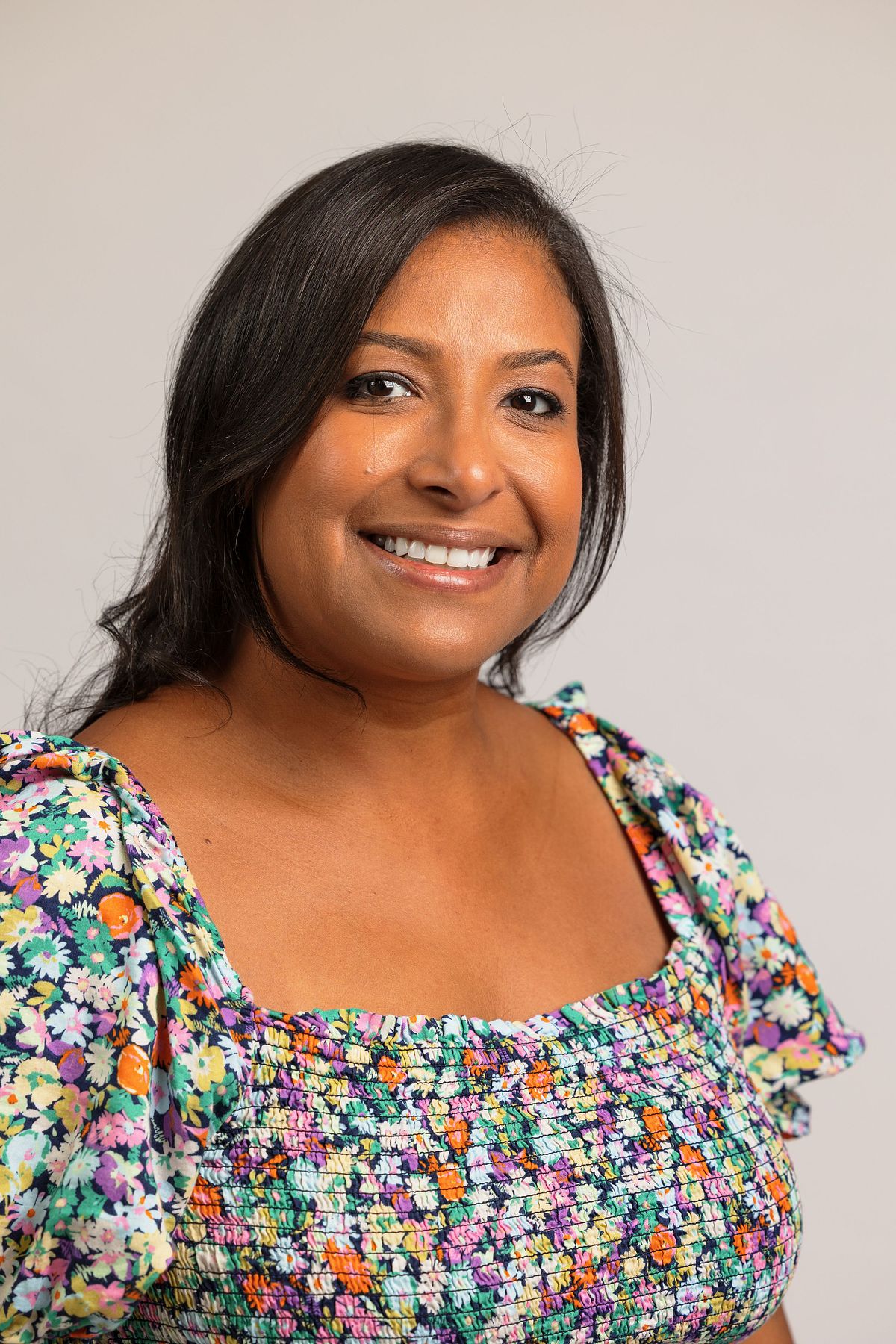 Close-up headshot photo of a woman against a white backdrop at Innovate Carolina's offices in Chapel Hill, NC