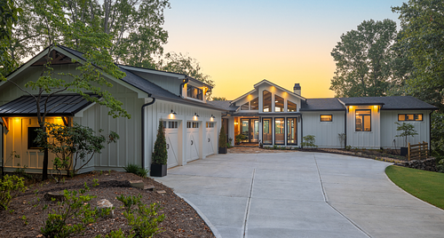 An overall view of the house from the driveway which incudes the garage