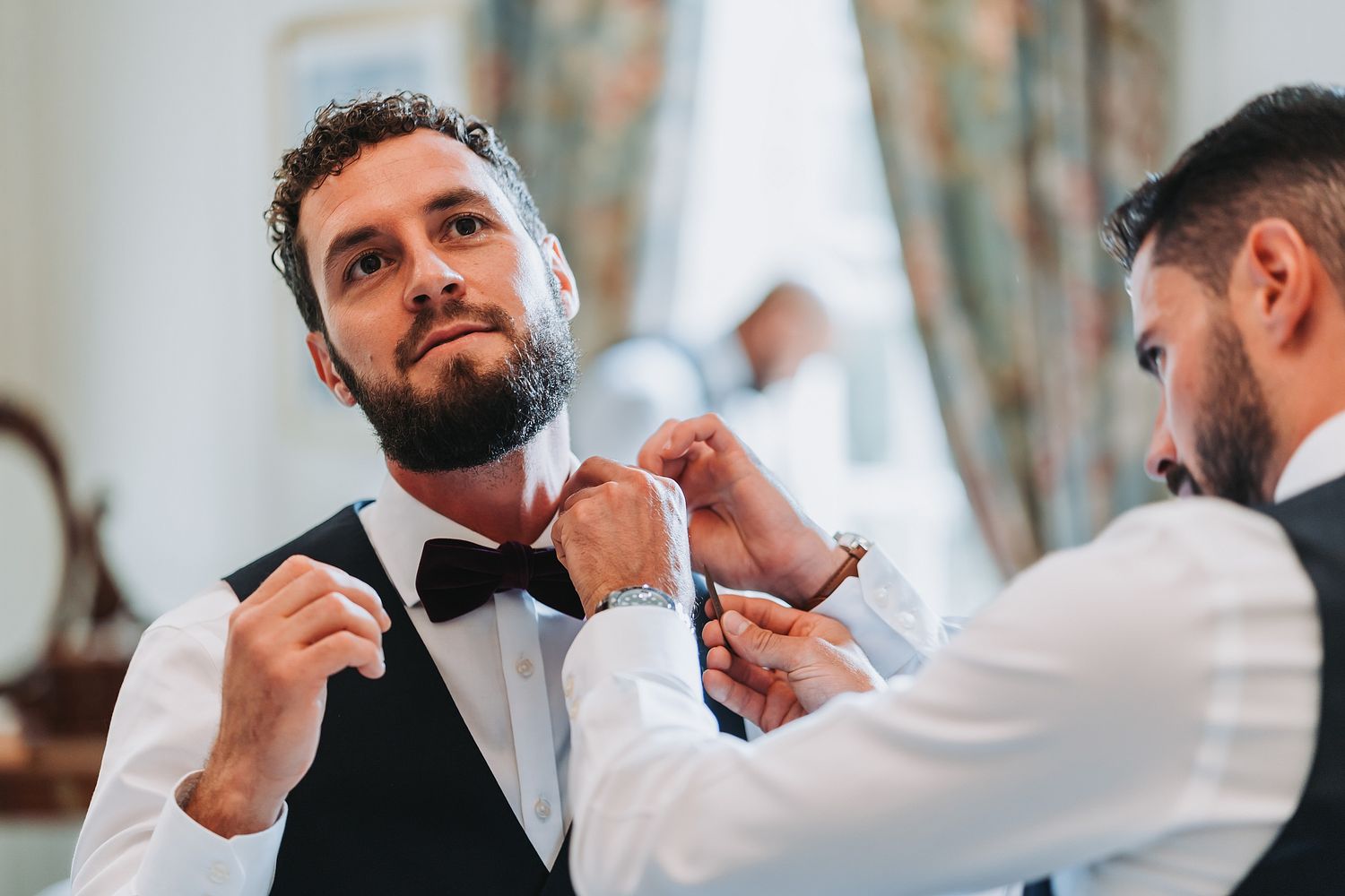 Groom and best mad getting ready