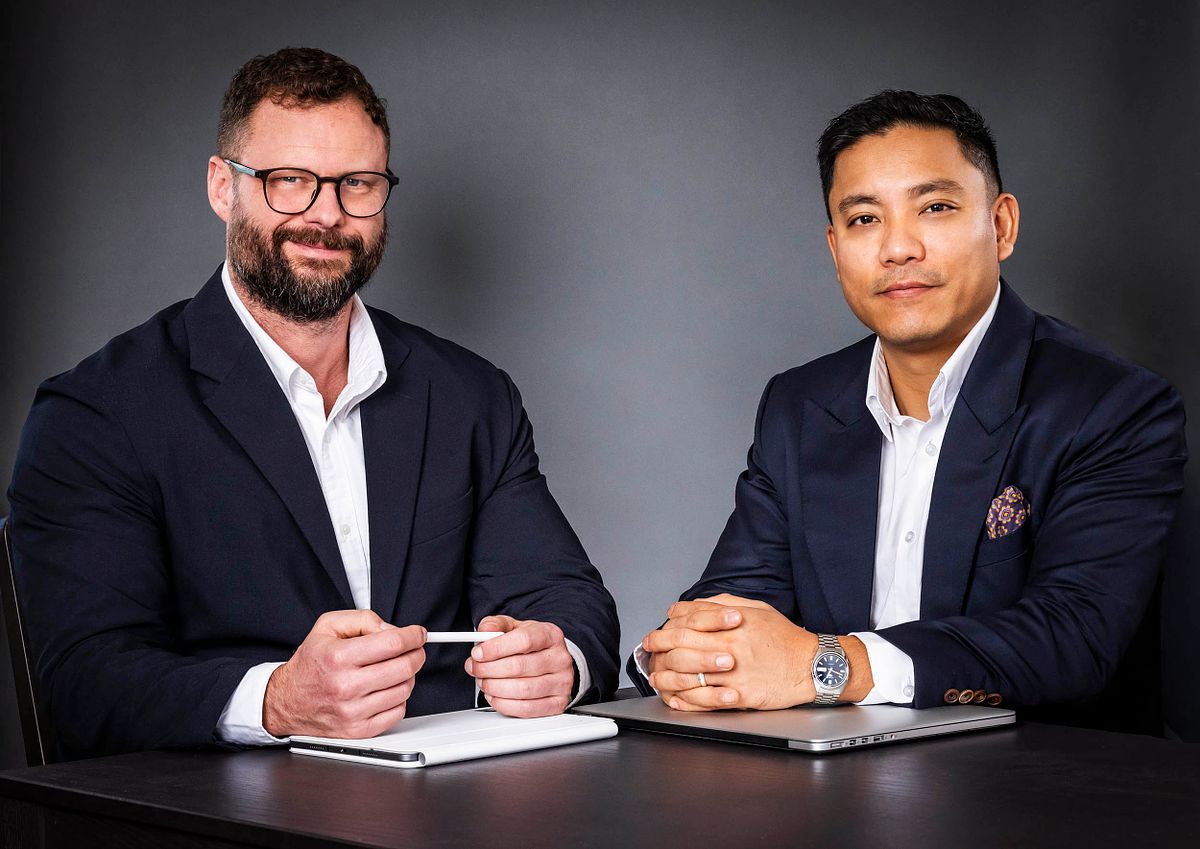 Corporate portraits of James Morris and Ron from Ambrose Finance. Dark grey background. wearing a suit.