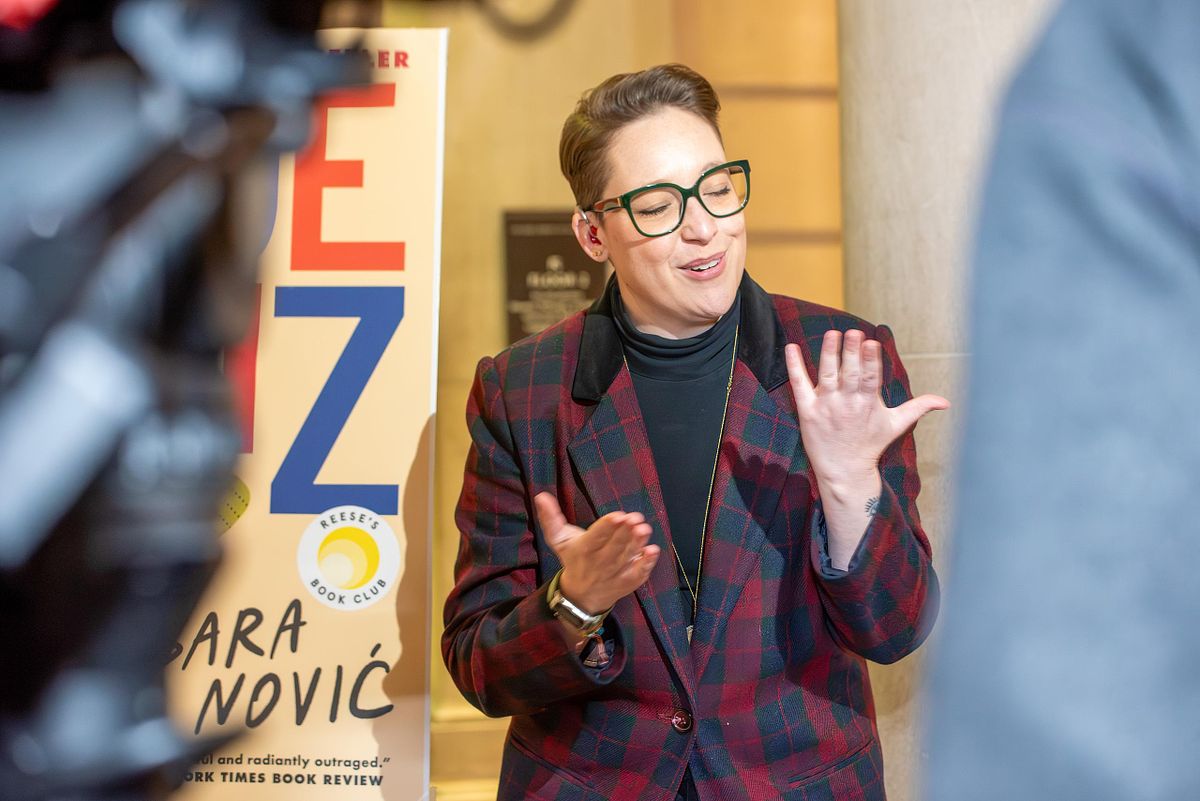 Author Sara Nović speaking in ASL during a press conference at the Free Library of Philadelphia, illustrating leadership communication moments at a public event.