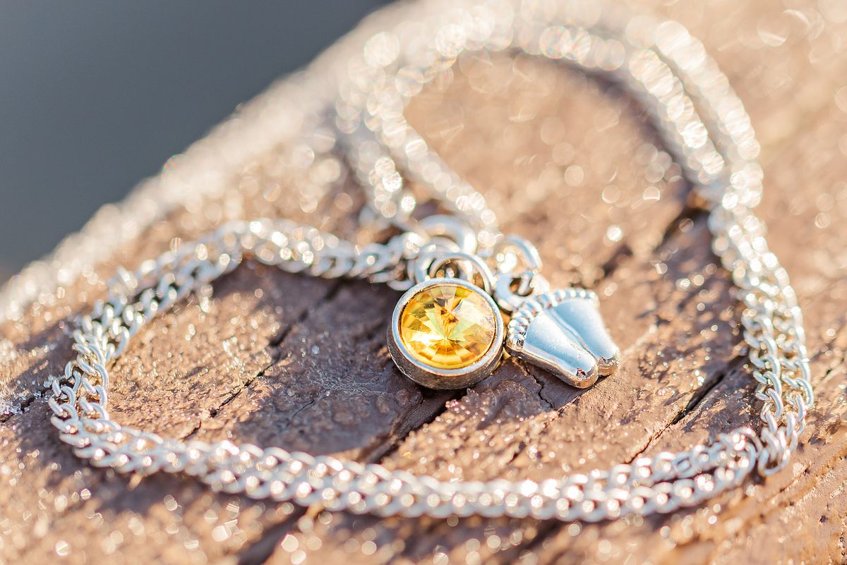 Necklace with tiny baby feet and November birth stone