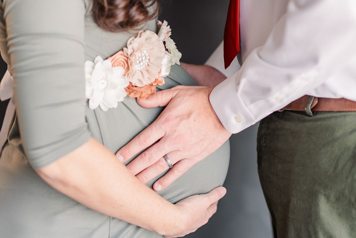 husband and wife facing each other holding her pregnant belly, faceless, session with Cranberry Township, PA photographer