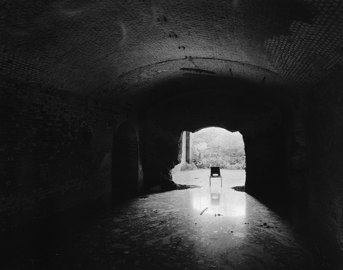 Flooded lower gallery of partially demolished Fort III