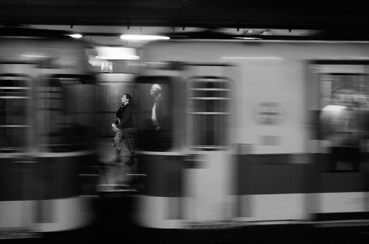 People standing still in a moving Milan subway train, captured by photographer Sandeep Gajula