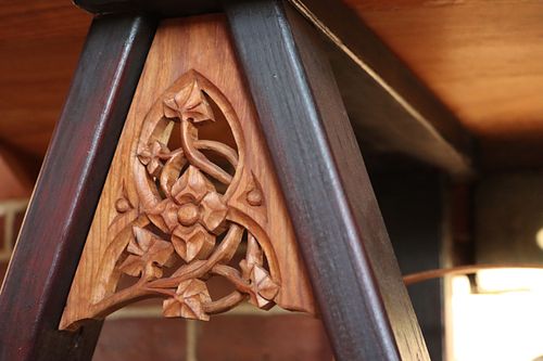 gothic cusped arch with vines and flower carving on trestle