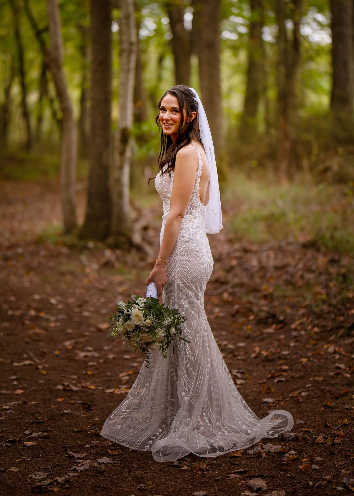 bride is posing in a wedding gown from downtown bridal salisbury on the eastern shore at fall forest wedding