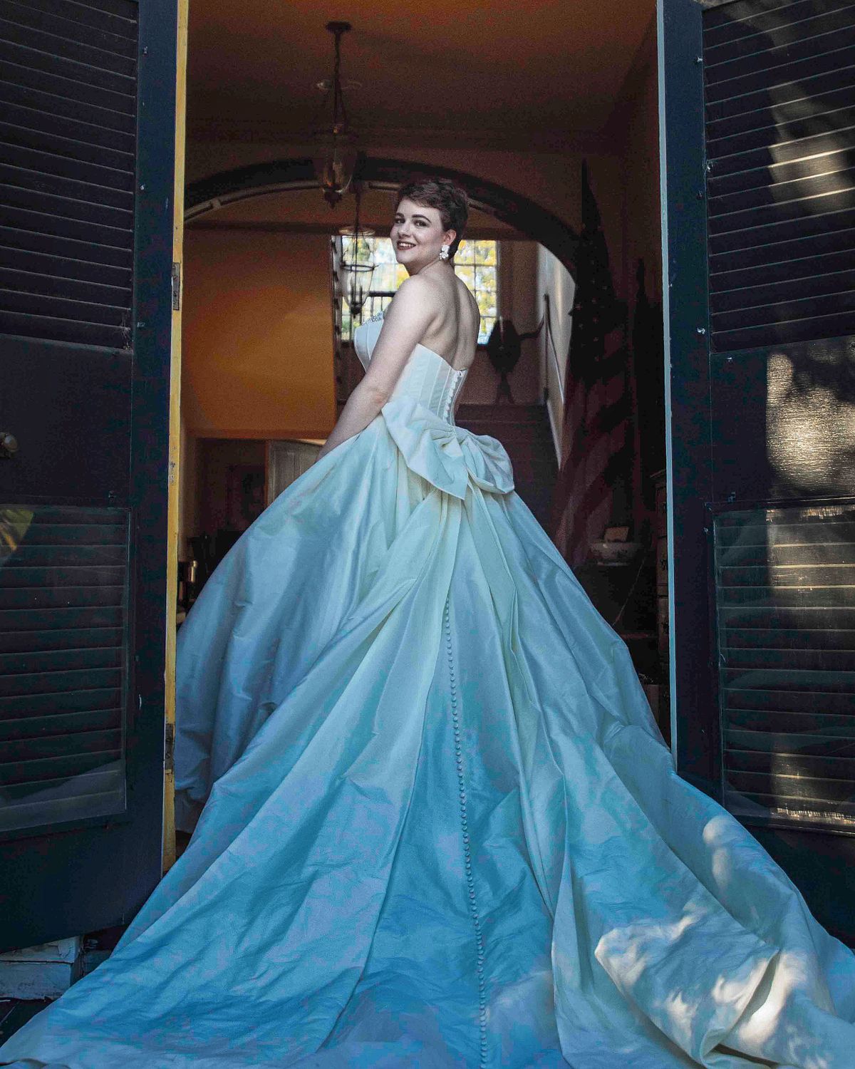 bride smiling inside doorway at poplar Hill mansion, Salisbury, md