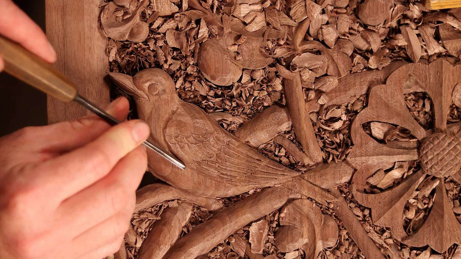 Wes Baker carving a robin on a door panel for a large shrine for St. Bernadette Catholic Church in Lancaster, Ohio