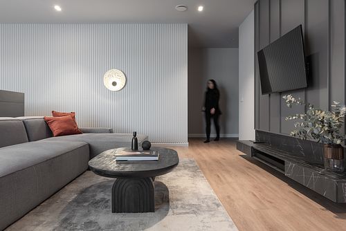 Minimalist high-end living room design with soft lighting and subtle human presence – Columna project