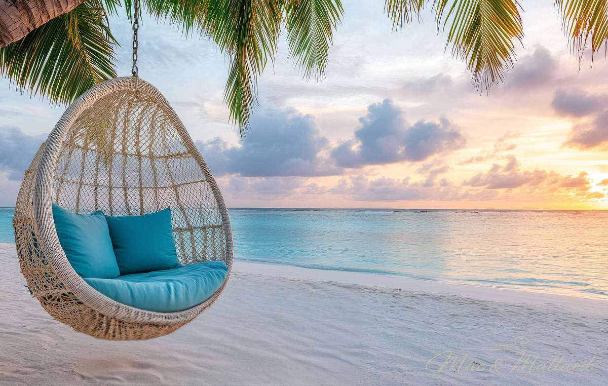 Tranquil beach setting with a hanging chair by the water at suns